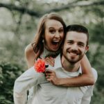 woman riding on back of man